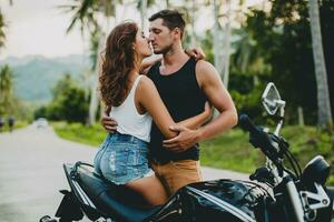 young couple in love, riding a motorcycle, hug, passion, free spirit photo