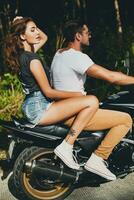 young couple in love, riding a motorcycle, hug, passion, free spirit photo