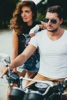 young couple in love, riding a motorcycle, hug, passion, free spirit photo