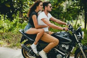 young couple in love, riding a motorcycle, hug, passion, free spirit photo