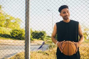 black man doing sports, playing basketball on sunrise, active lifestyle, sunny summer morning photo