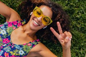 young stylish black woman having fun in park summer fashion style photo