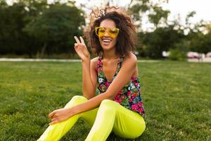 young stylish black woman having fun in park summer fashion style photo