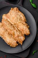 Delicious fried chicken chop or pork meat fried breaded with salt, spices and herbs photo