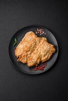 Delicious fried chicken chop or pork meat fried breaded with salt, spices and herbs photo