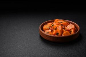 Delicious stewed sweet potato with salt, spices and herbs photo