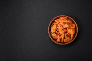 Delicious stewed sweet potato with salt, spices and herbs photo