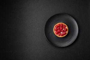 Delicious fresh sweet round tart with ripe raspberries and cream photo