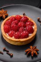 Delicious fresh sweet round tart with ripe raspberries and cream photo