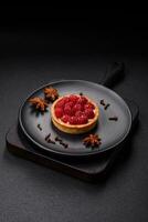 Delicious fresh sweet round tart with ripe raspberries and cream photo