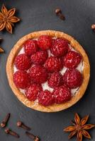 Delicious fresh sweet round tart with ripe raspberries and cream photo