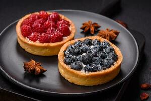 Delicious fresh sweet round tart with ripe blueberries and cream photo