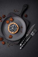 Delicious fresh sweet round tart with ripe blueberries and cream photo