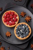 Delicious fresh sweet round tart with ripe blueberries and cream photo