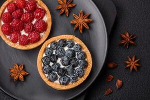Delicious fresh sweet round tart with ripe blueberries and cream photo