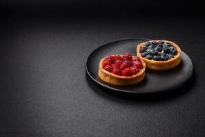 Delicious fresh sweet round tart with ripe raspberries and cream photo
