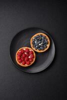 Delicious fresh sweet round tart with ripe raspberries and cream photo