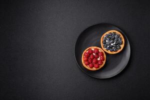 Delicious fresh sweet round tart with ripe raspberries and cream photo