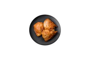 Delicious grilled chicken thighs with salt, spices and herbs photo