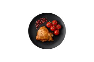 Delicious grilled chicken thighs with salt, spices and herbs photo