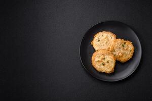 Delicious fried minced fish cutlets or meatballs with salt, spices and herbs photo