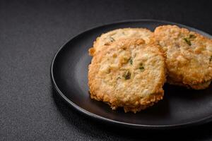 Delicious fried minced fish cutlets or meatballs with salt, spices and herbs photo