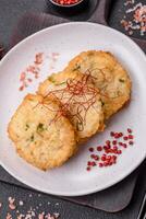 Delicious fried minced fish cutlets or meatballs with salt, spices and herbs photo