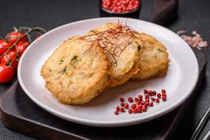 Delicious fried minced fish cutlets or meatballs with salt, spices and herbs photo