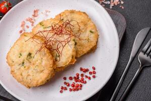 Delicious fried minced fish cutlets or meatballs with salt, spices and herbs photo