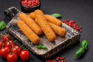 Delicious crispy cheese sticks with mozzarella, salt and spices, breaded and fried in oil photo