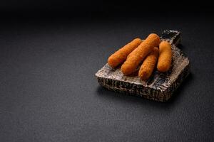 Delicious crispy cheese sticks with mozzarella, salt and spices, breaded and fried in oil photo