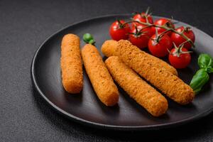 Delicious crispy cheese sticks with mozzarella, salt and spices, breaded and fried in oil photo