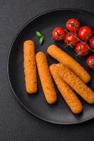 Delicious crispy cheese sticks with mozzarella, salt and spices, breaded and fried in oil photo