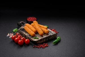 Delicious crispy cheese sticks with mozzarella, salt and spices, breaded and fried in oil photo