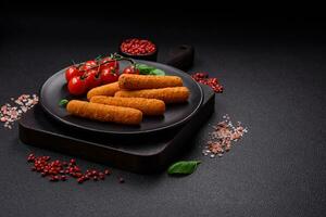 Delicious crispy cheese sticks with mozzarella, salt and spices, breaded and fried in oil photo