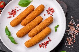 Delicious crispy cheese sticks with mozzarella, salt and spices, breaded and fried in oil photo