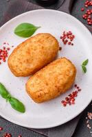 Delicious baked potato cutlet stuffed with chicken and vegetables, spices and salt photo