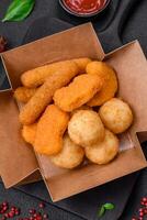 Delicious nuggets, sticks and balls of mozzarella and parmesan cheese with salt and spices photo