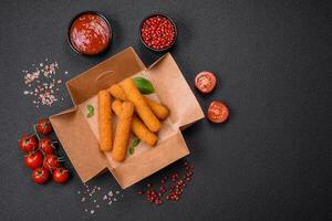 Delicious crispy cheese sticks with mozzarella, salt and spices, breaded and fried in oil photo