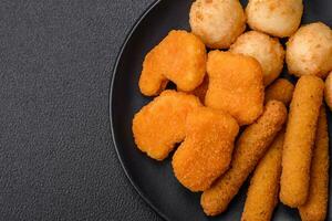 Delicious nuggets, sticks and balls of mozzarella and parmesan cheese with salt and spices photo