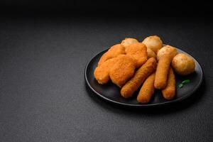 Delicious nuggets, sticks and balls of mozzarella and parmesan cheese with salt and spices photo