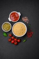 Raw whole grain orzo pasta as an ingredient for a delicious dish photo