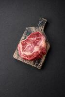 Fresh juicy raw beef striploin steak with salt and spices photo