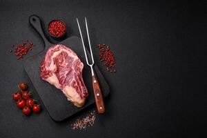 Fresh juicy raw beef striploin steak with salt and spices photo