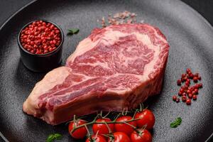 Fresh juicy raw beef striploin steak with salt and spices photo