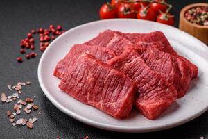 Fresh juicy raw beef slices with salt and spices photo