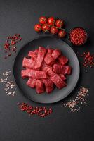 Fresh juicy raw beef slices with salt and spices photo