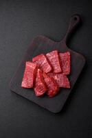 Fresh juicy raw beef slices with salt and spices photo