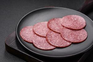 Delicious fresh smoked sausage with salt and spices cut into slices photo