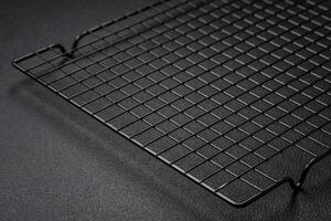 Empty black metal kitchen grate for pouring desserts photo